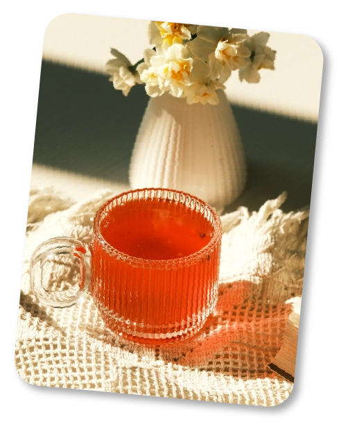 Warm floral tisane served in sunlit room with botanicals